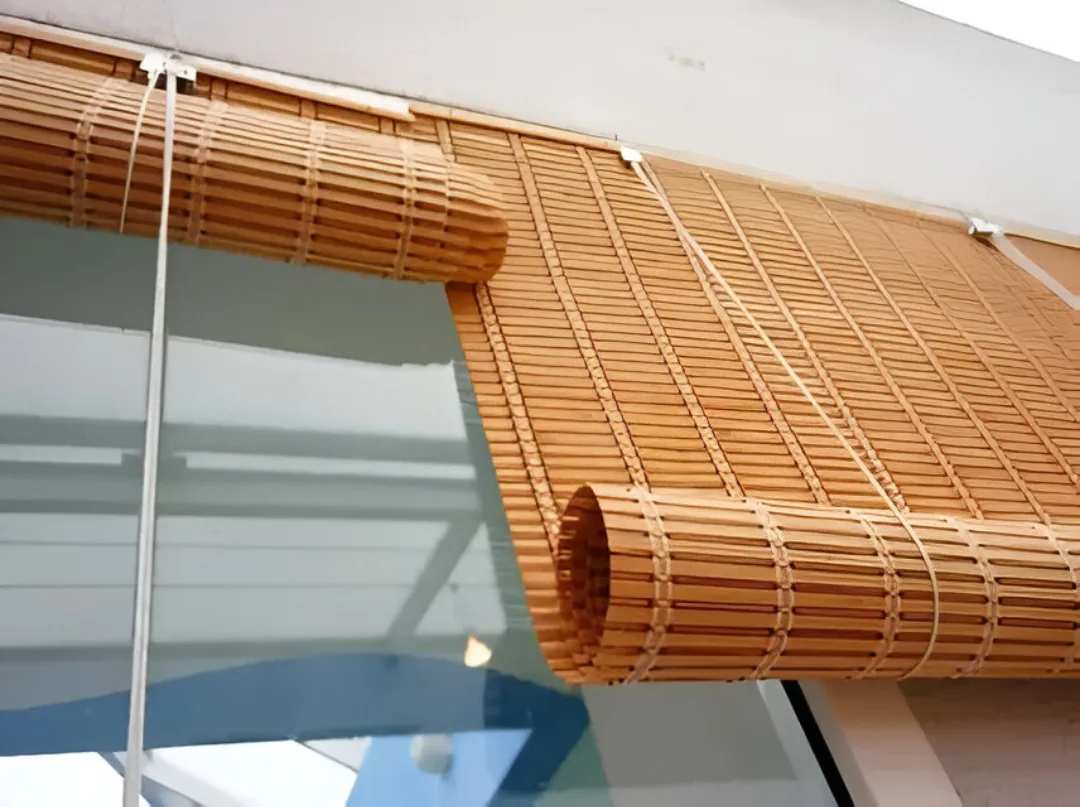 Eco-friendly bamboo blinds fitted on windows in a Bengaluru home, bringing a warm natural texture and filtered sunlight.