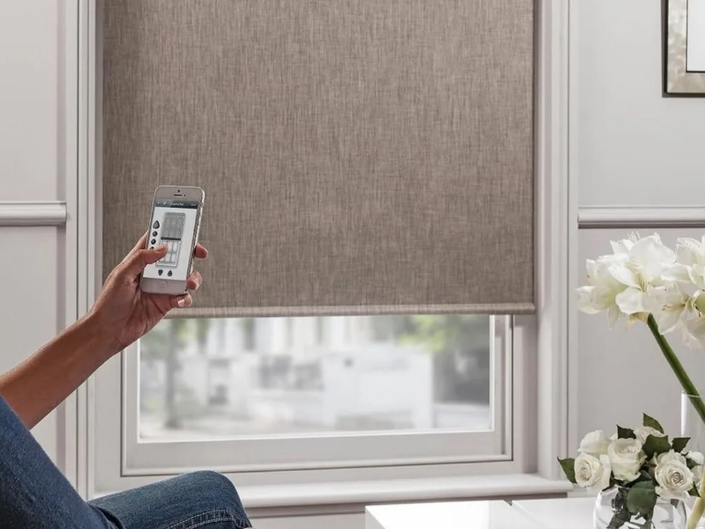 Modern motorized blinds operated remotely on large windows in a Bengaluru smart home, offering comfort and convenience with automated control.