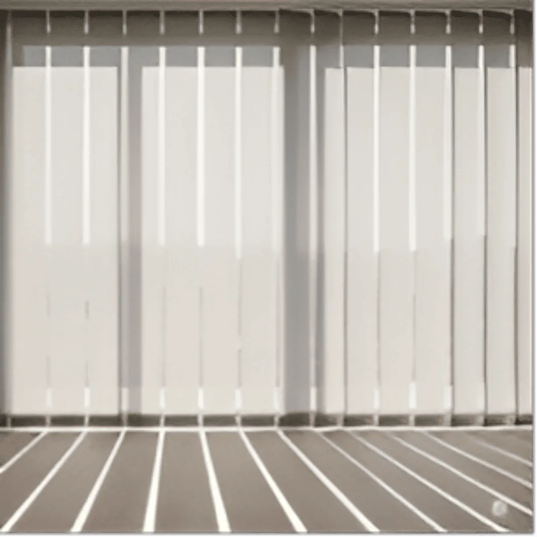 A set of elegant vertical blinds, featuring wide, off-white fabric louvres, is shown from a slightly low angle. The blinds are partially open, allowing soft, diffused sunlight to filter into a modern living room. The light creates distinct, elongated shadows on a light-wood floor. 